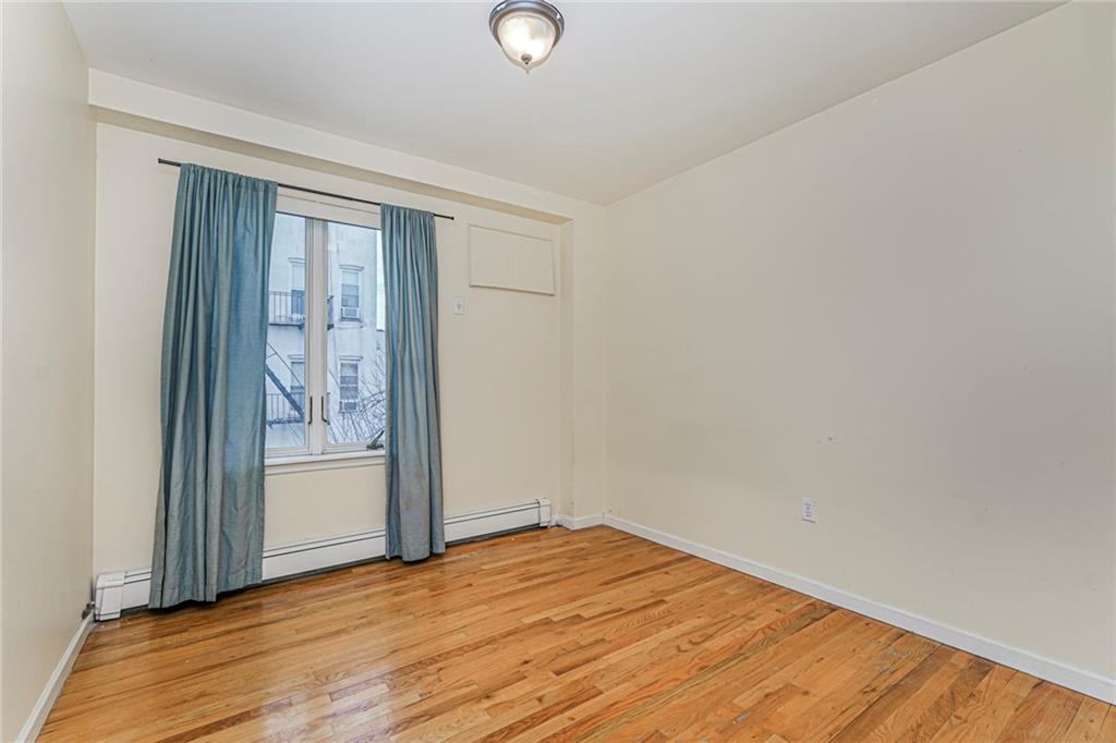 1838 West 13th Street, Unit 3B Brooklyn, NY 11223 - Photo 15 of 22 an empty room with wooden floor and windows