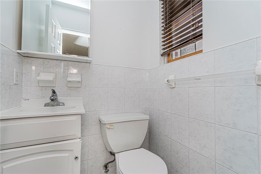 1838 West 13th Street, Unit 3B Brooklyn, NY 11223 - Photo 18 of 22 a bathroom with a toilet sink and mirror