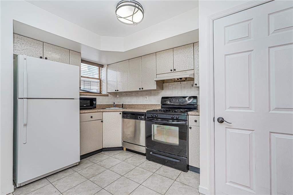 1838 West 13th Street, Unit 3B Brooklyn, NY 11223 - Photo 9 of 22 a kitchen with a refrigerator sink and cabinets