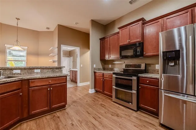 a kitchen with stainless steel appliances and wooden cabinets