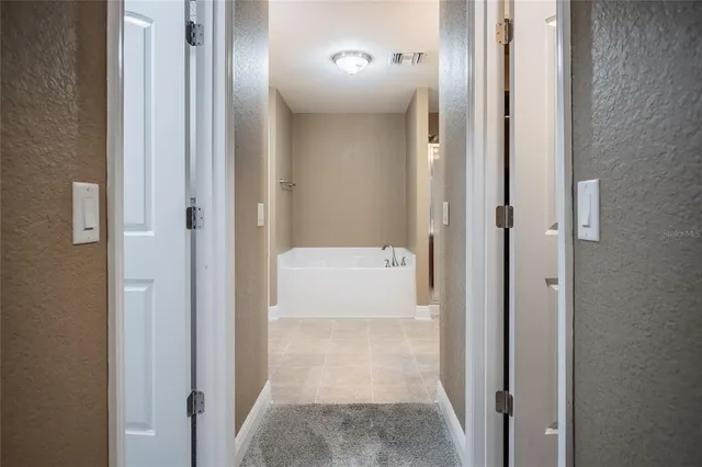 a view of a bathroom from a corridor