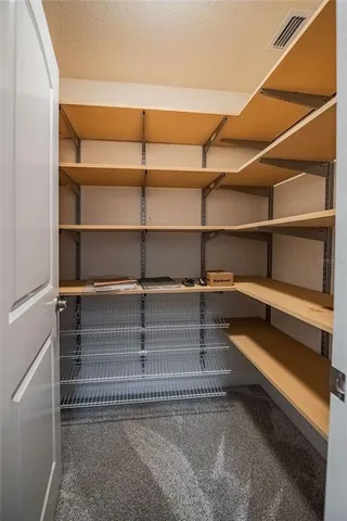 a view of walk in closet with empty racks