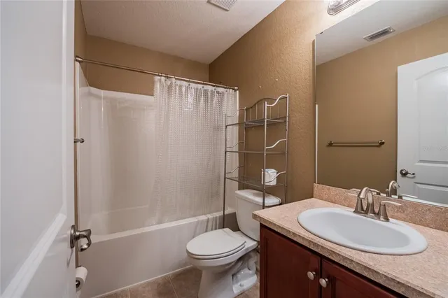 a bathroom with a sink toilet mirror and shower