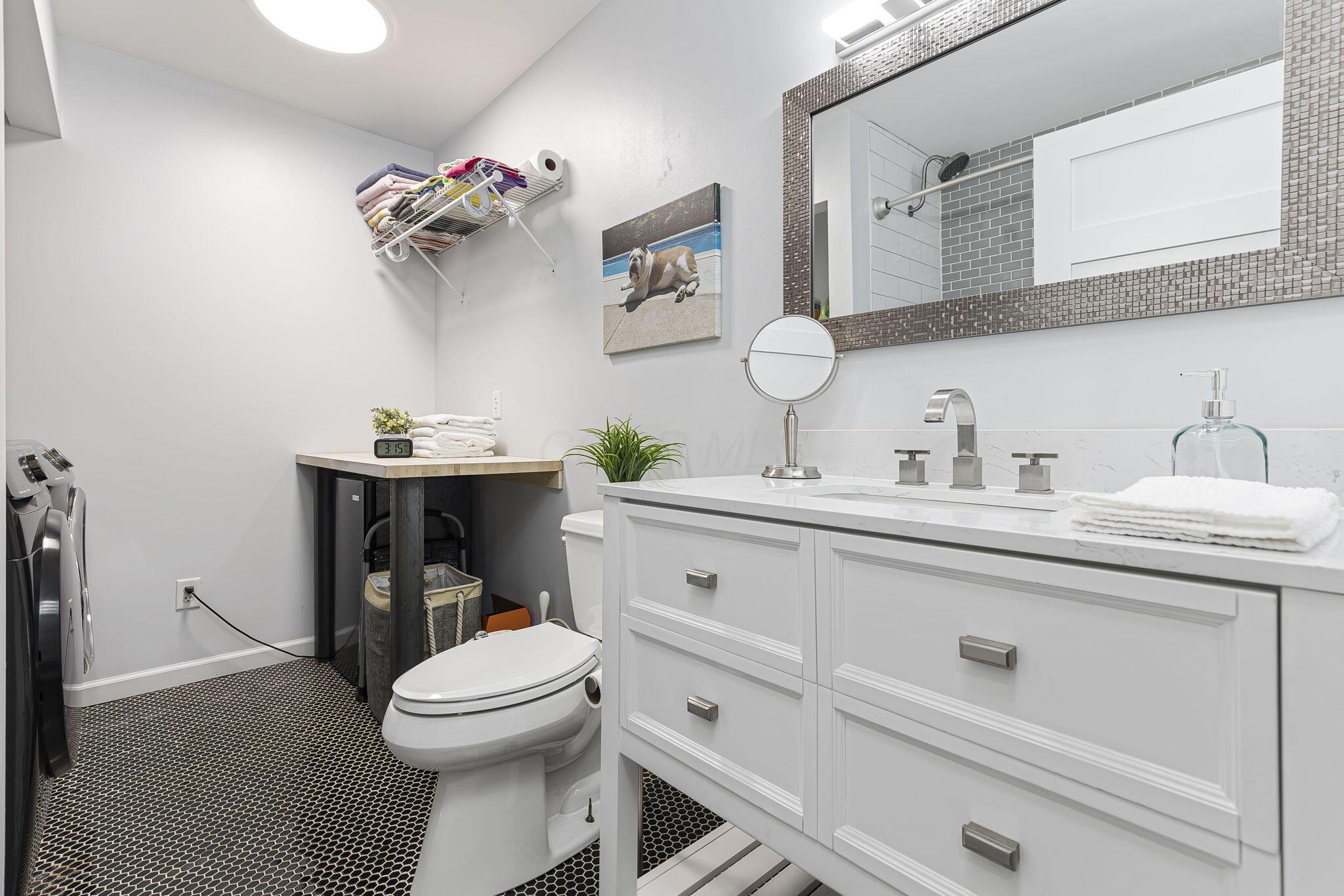 7140 Cook Road Powell, OH 43065 - Photo 56 of 87 Spa-inspired bathroom featuring a white shaker-style vanity with multiple drawers, polished chrome hardware, and a rectangular white porcelain sink
