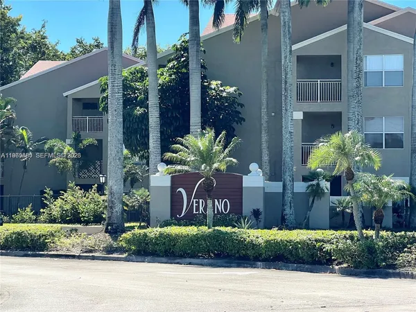 a front view of a house with a yard and a garden