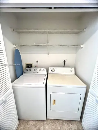 a bathroom with a double vanity sink toilet mirror and bathtub