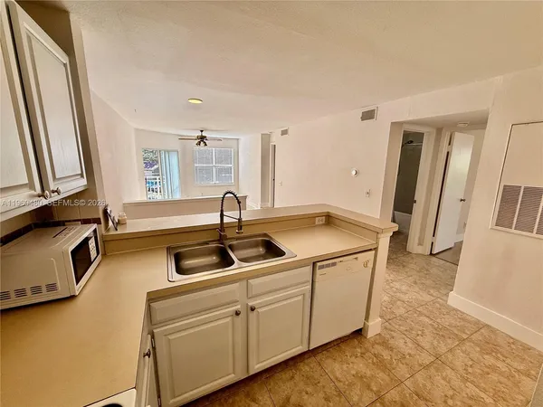 a kitchen with a sink and cabinets