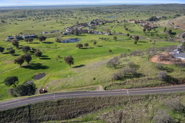 an aerial view of field with trees