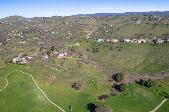 an aerial view of a residential houses with outdoor space
