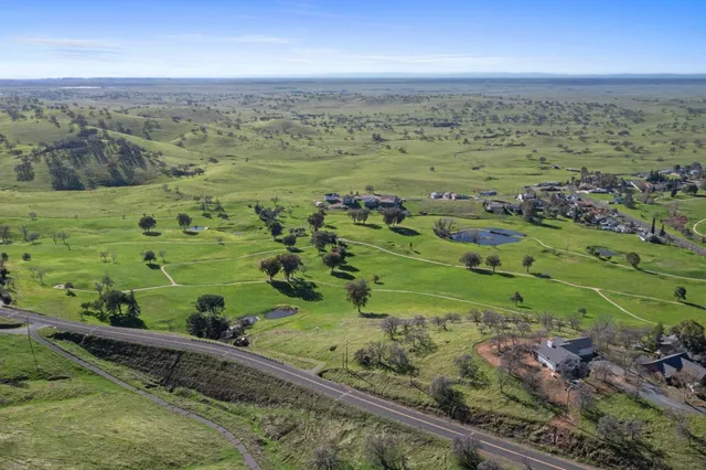 a view of a field with an ocean