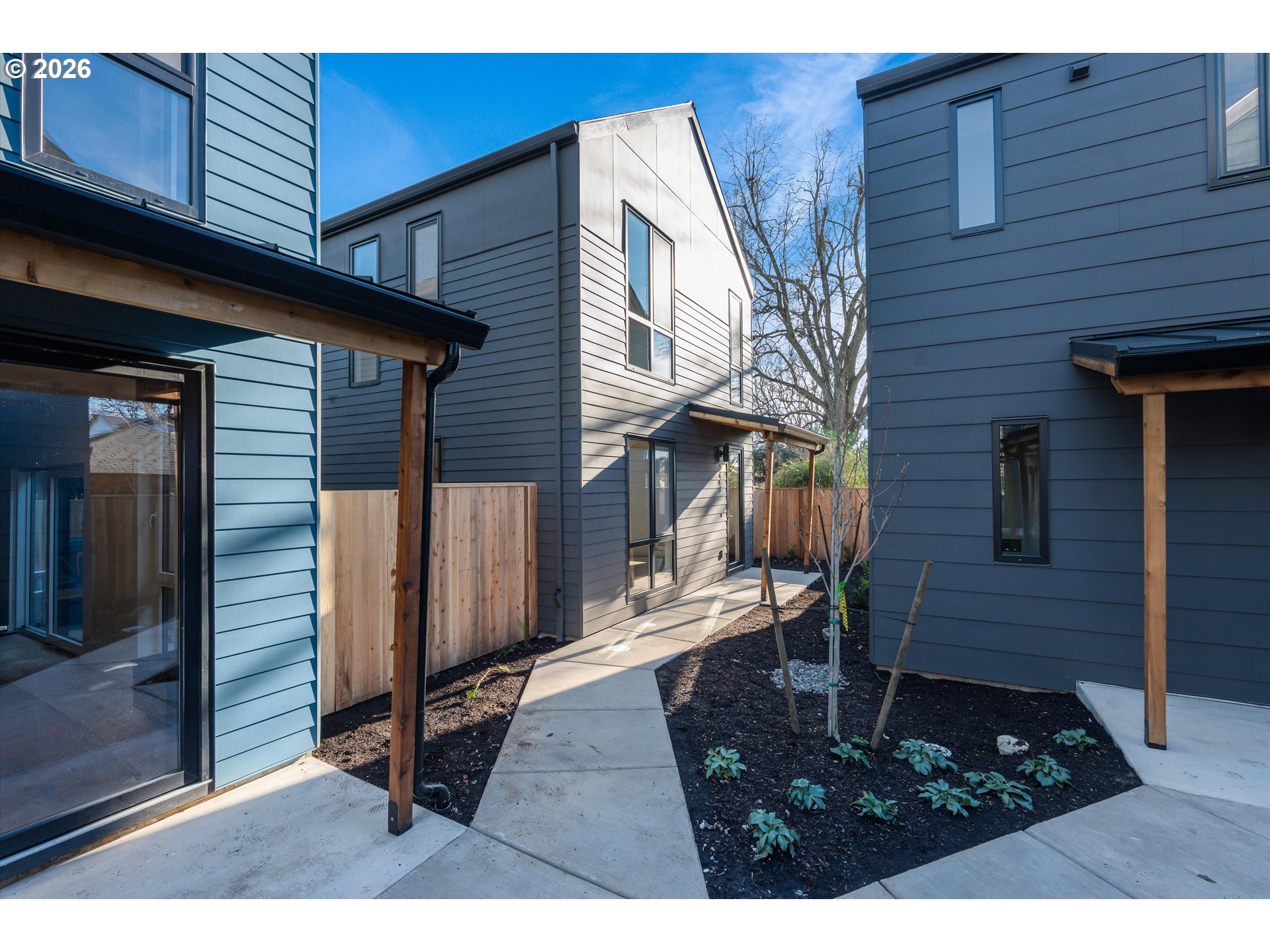 5490 Southeast Boise Street Portland, OR 97206 - Photo 2 of 48 a backyard of a house with barbeque oven and outdoor seating