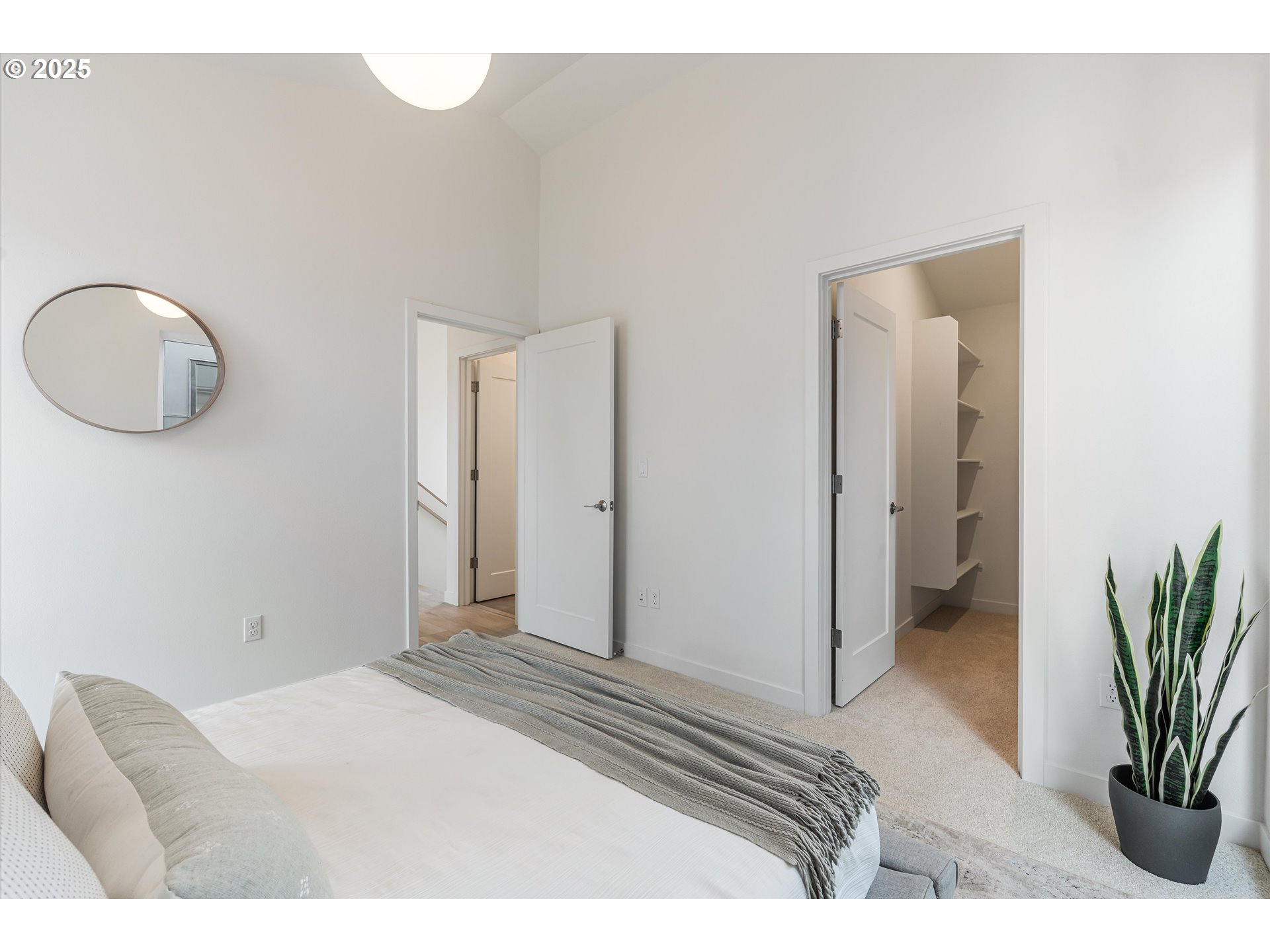 5490 Southeast Boise Street Portland, OR 97206 - Photo 23 of 48 a bedroom with a bed and a potted plant