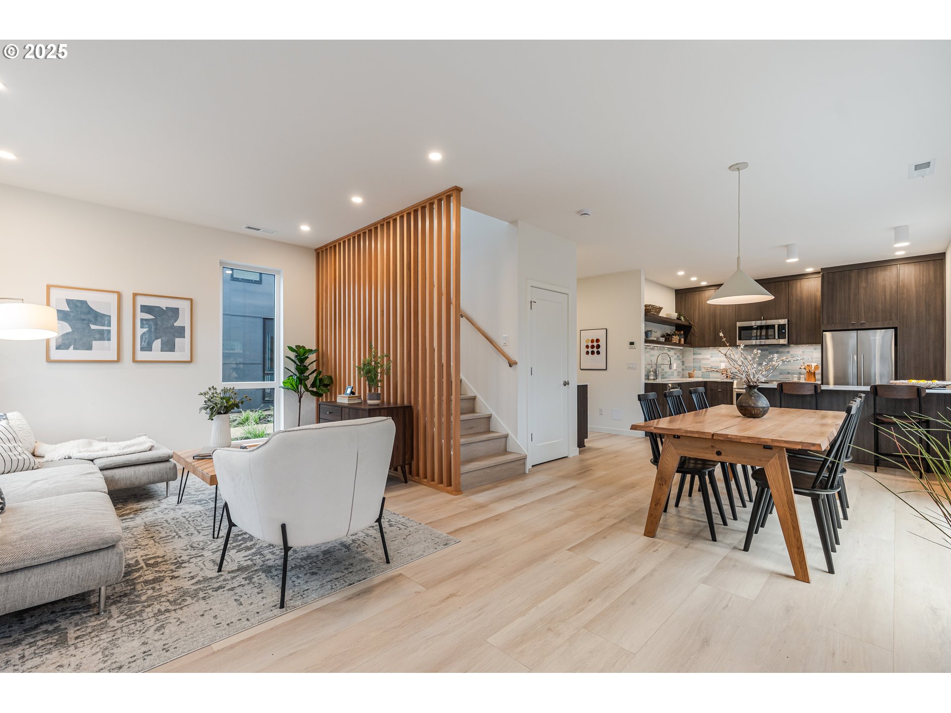 5490 Southeast Boise Street Portland, OR 97206 - Photo 6 of 48 a living room with furniture a dining table and a potted plant