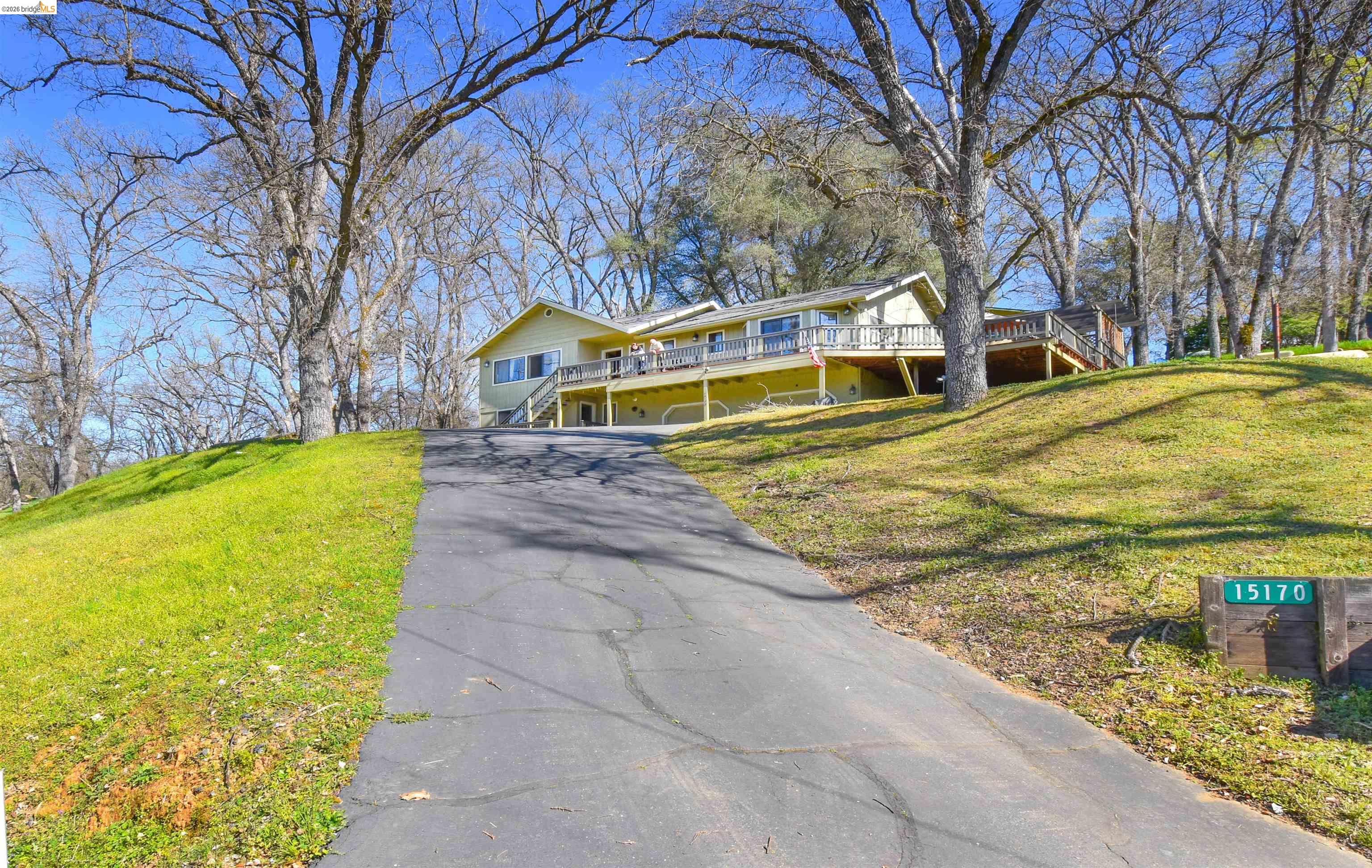 15170 Potato Ranch Road Sonora, CA 95370 - Photo 48 of 49 View of front of house with driveway, a front lawn, and a wooden deck
