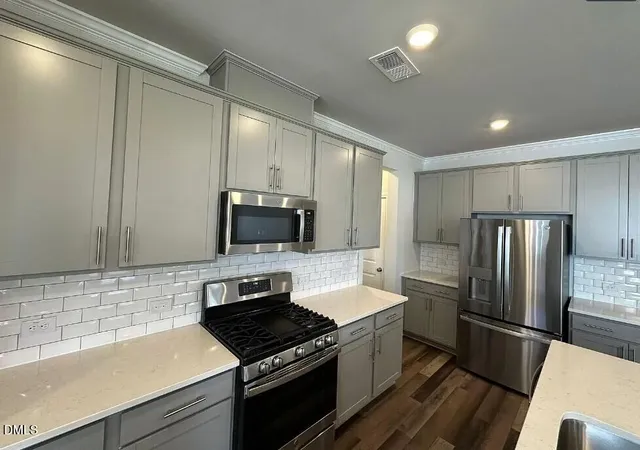 a kitchen with a refrigerator stove and microwave