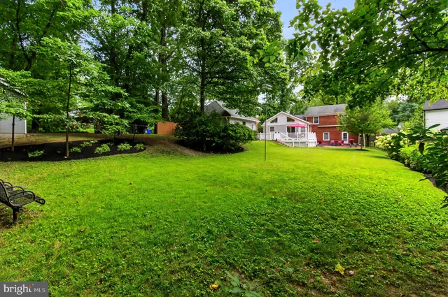 a backyard of a house with yard and trampoline