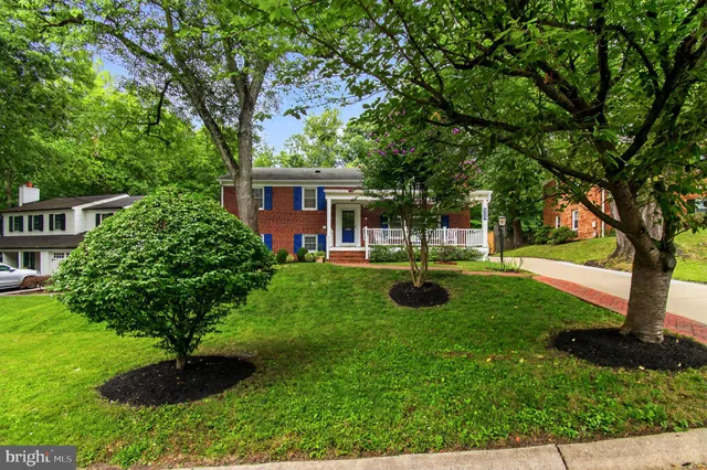 a view of a house with backyard sitting area and garden
