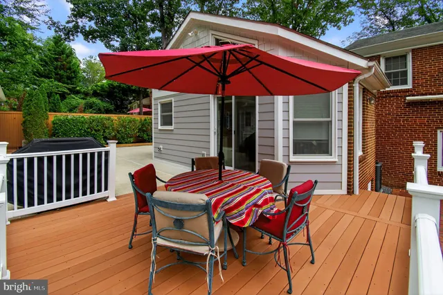 a patio with a table and chairs under an umbrella