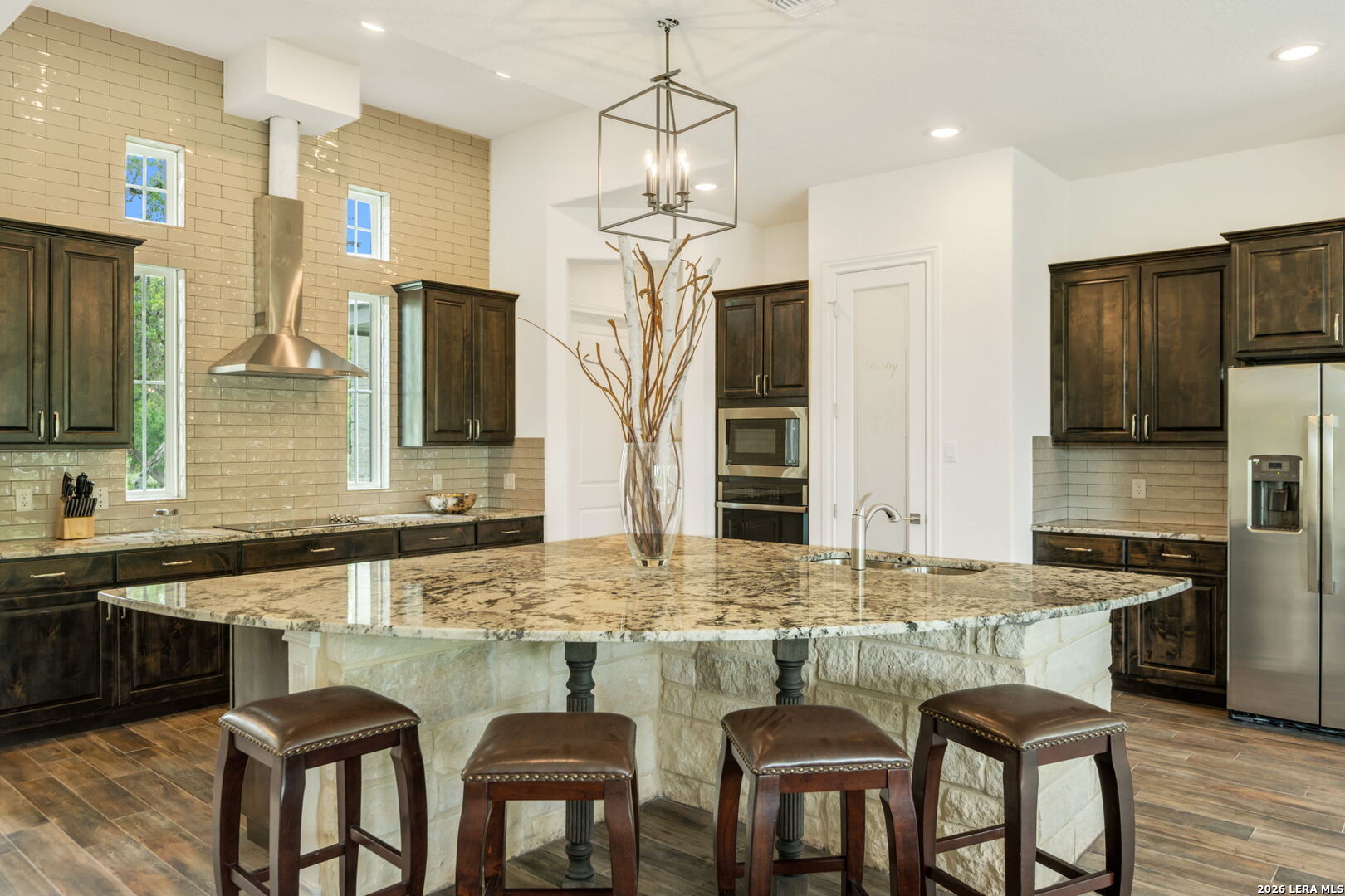 1465 Ironwood Road Fischer, TX 78623 - Photo 11 of 38 a kitchen with granite countertop a sink cabinets and stainless steel appliances