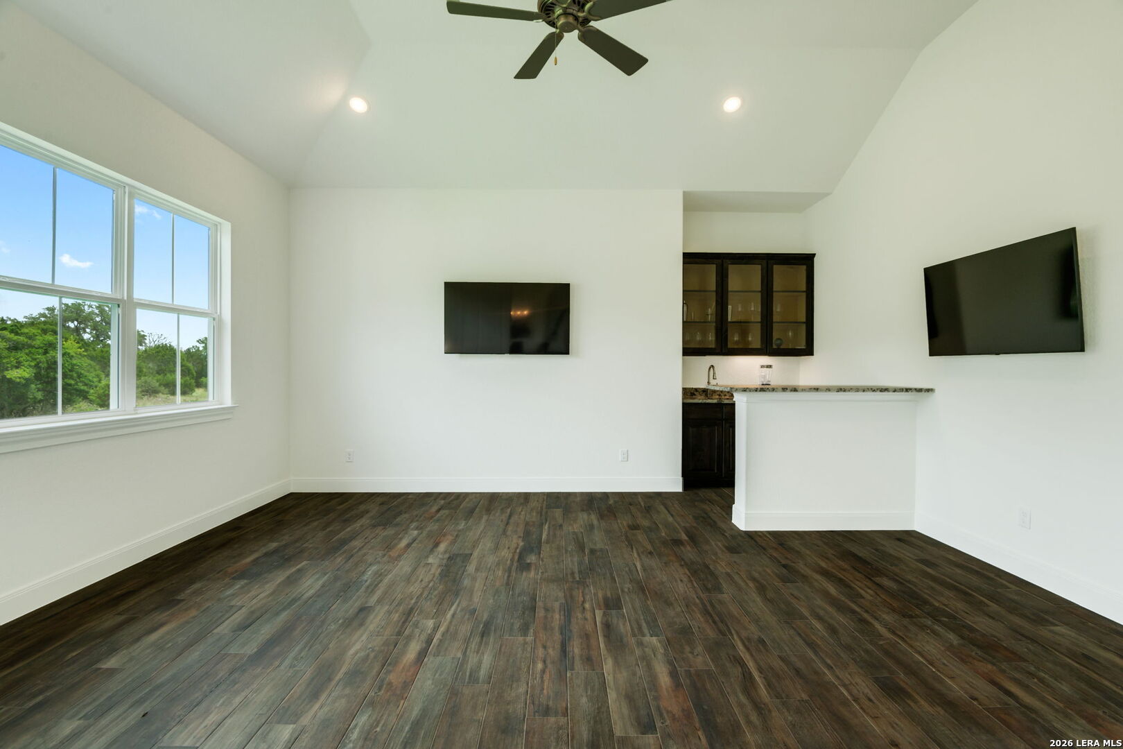 1465 Ironwood Road Fischer, TX 78623 - Photo 18 of 38 a view of a livingroom with wooden floor and a flat screen tv
