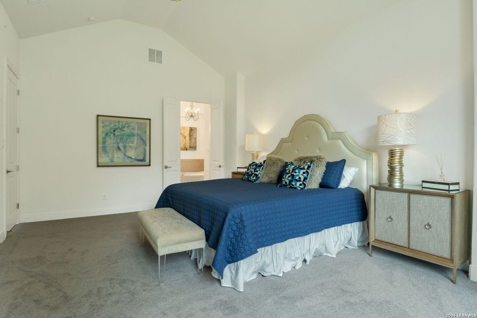 1465 Ironwood Road Fischer, TX 78623 - Photo 23 of 38 a bedroom with a bed and a chandelier
