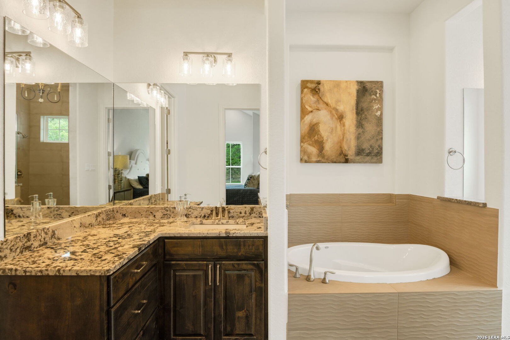 1465 Ironwood Road Fischer, TX 78623 - Photo 24 of 38 a bathroom with a granite countertop sink and a mirror