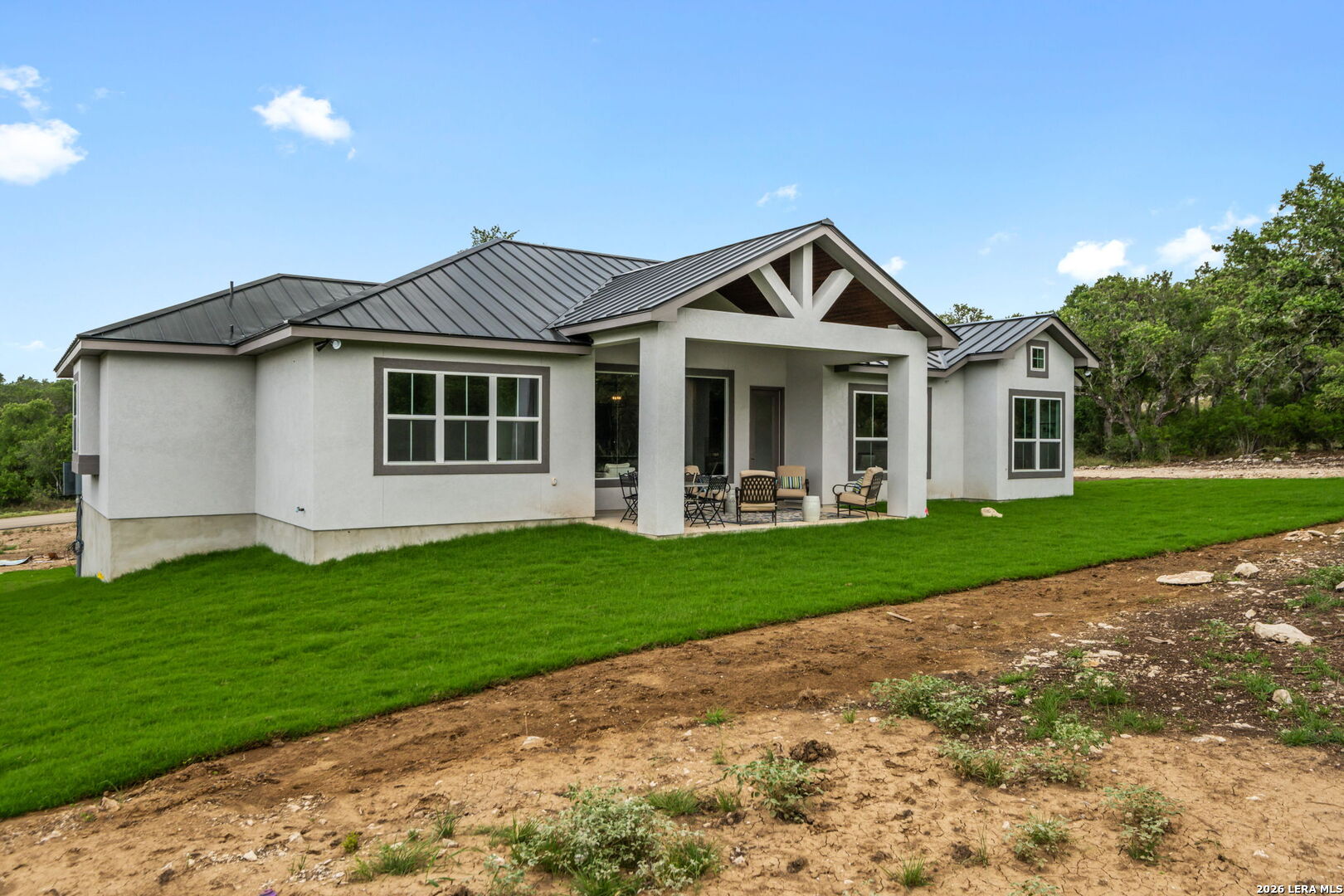 1465 Ironwood Road Fischer, TX 78623 - Photo 32 of 38 a front view of a house with a garden and yard