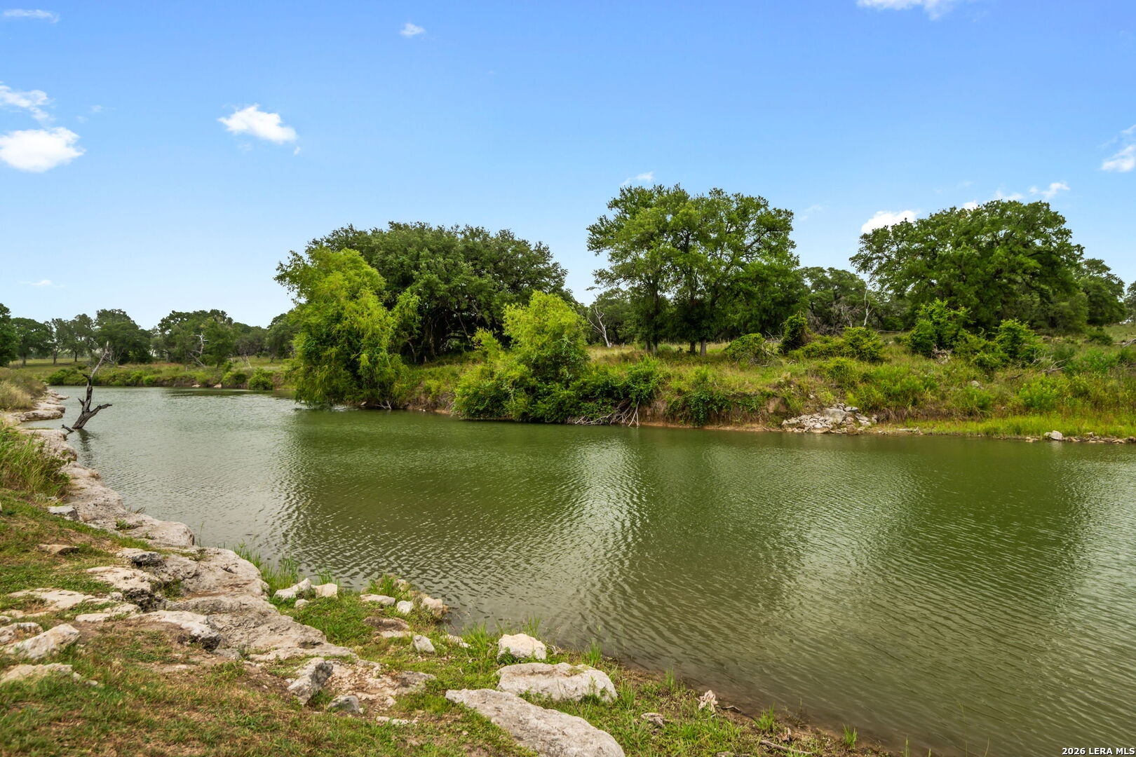 1465 Ironwood Road Fischer, TX 78623 - Photo 35 of 38 a view of a lake with a yard