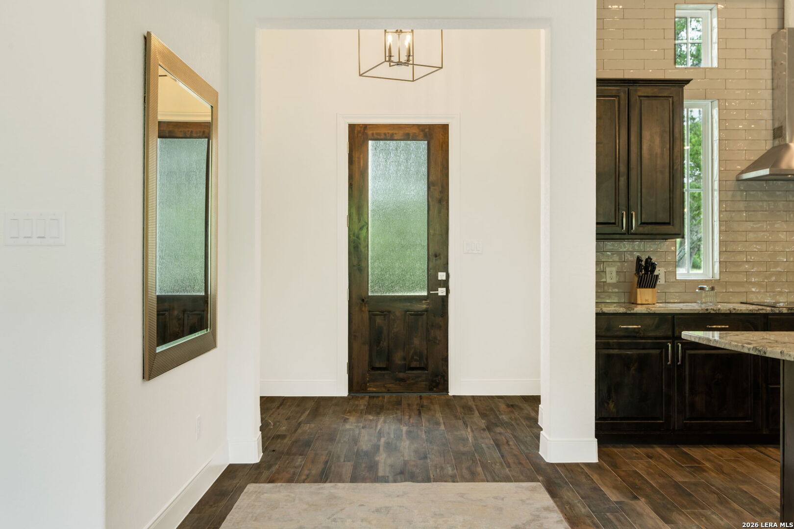1465 Ironwood Road Fischer, TX 78623 - Photo 5 of 38 a view of a hallway with wooden floor and cabinets