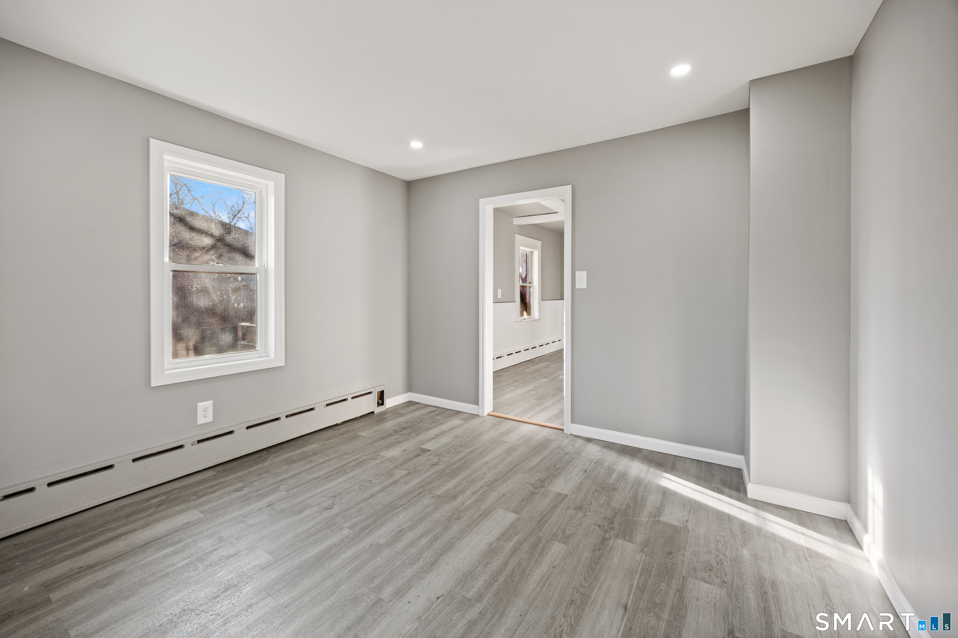 153 Funston Avenue, Unit 1 Torrington, CT 06790 - Photo 7 of 16 wooden floor in an empty room with a window