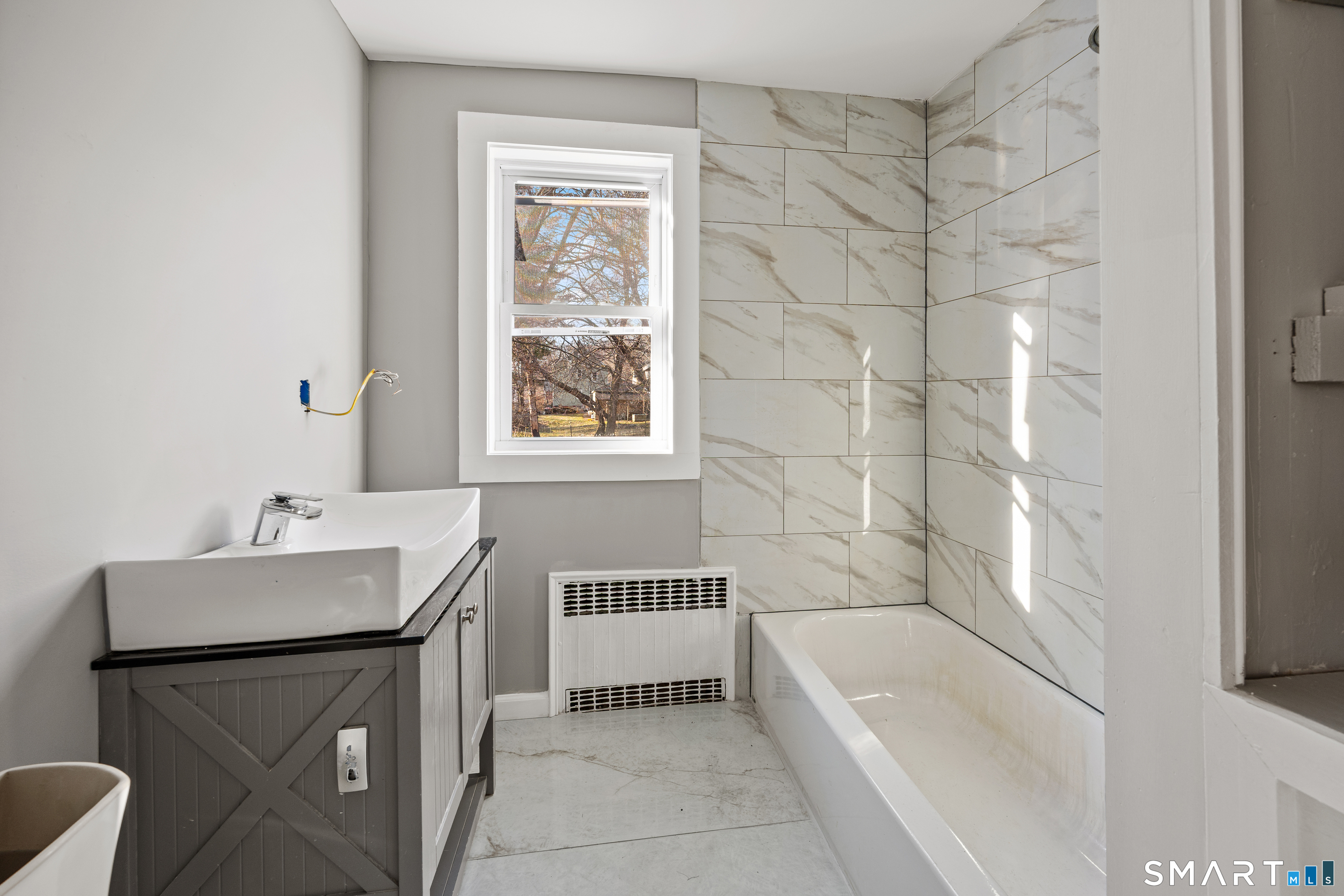 153 Funston Avenue, Unit 1 Torrington, CT 06790 - Photo 9 of 16 a bathroom with a sink a toilet and bathtub