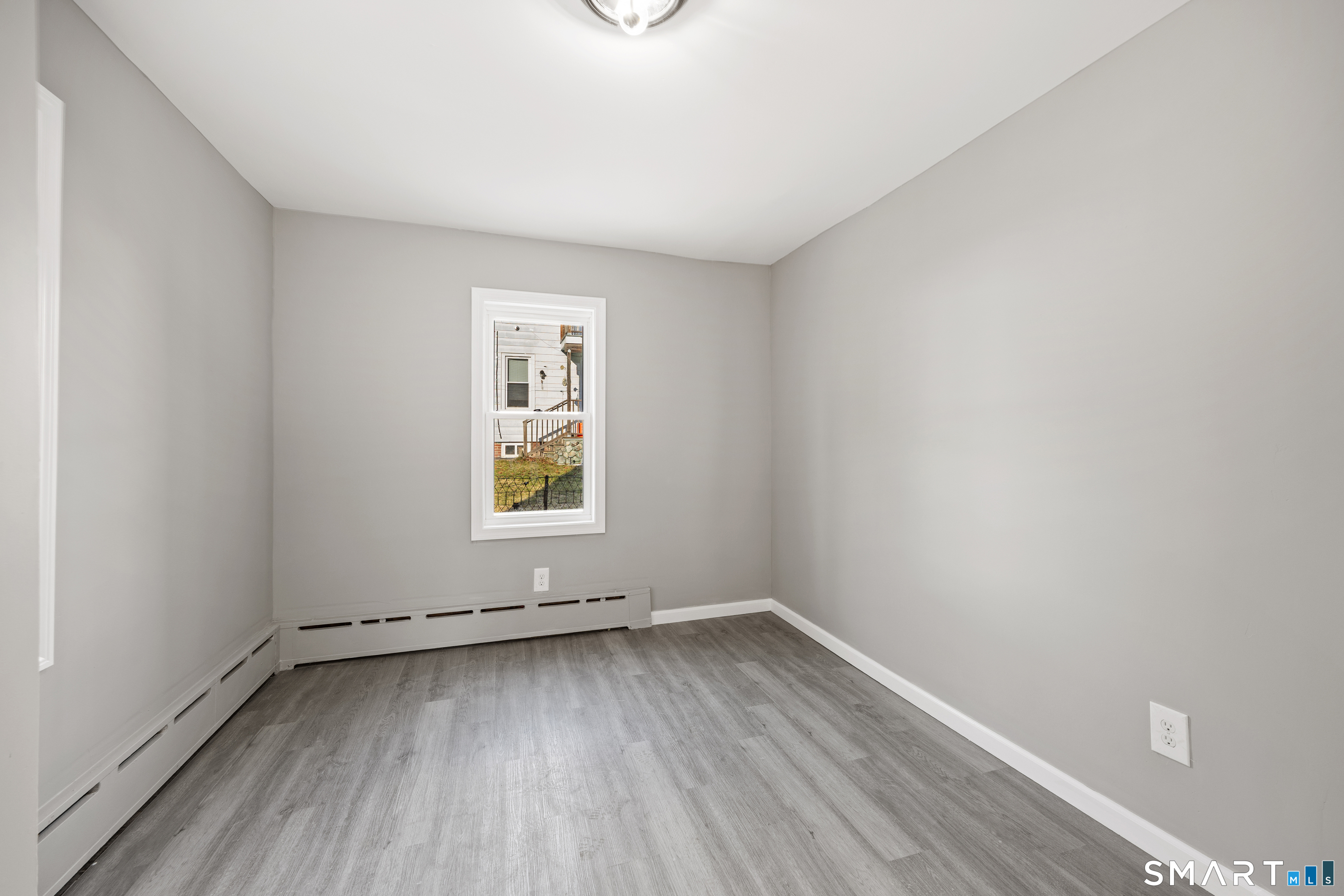 153 Funston Avenue, Unit 1 Torrington, CT 06790 - Photo 10 of 16 wooden floor in an empty room with a window