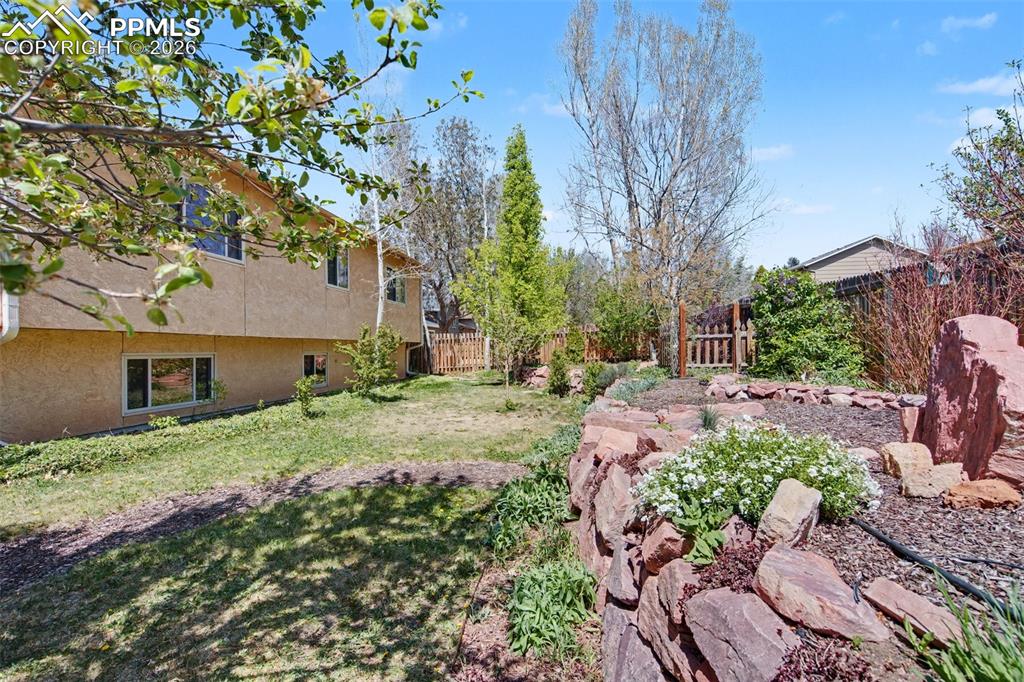 5301 Pinon Valley Road Colorado Springs, CO 80919 - Photo 25 of 27 a backyard of a house with lots of green space