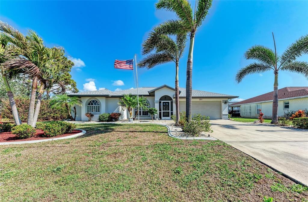 221 Fairway Road Rotonda West, FL 33947 - Photo 1 of 1 a view of a house with a yard and palm trees