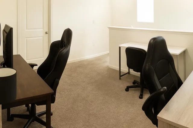 a view of a workspace with furniture and a chair