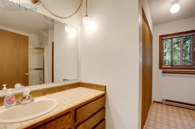 a view of a livingroom with lounge chair and windows