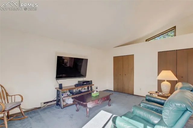 a living room with furniture a rug and a window
