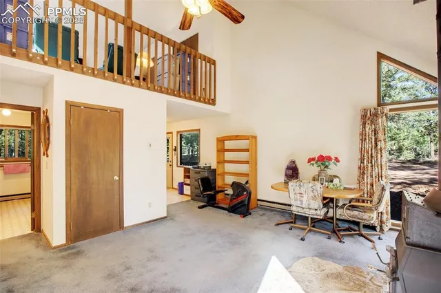 a view of a livingroom with workspace and a window