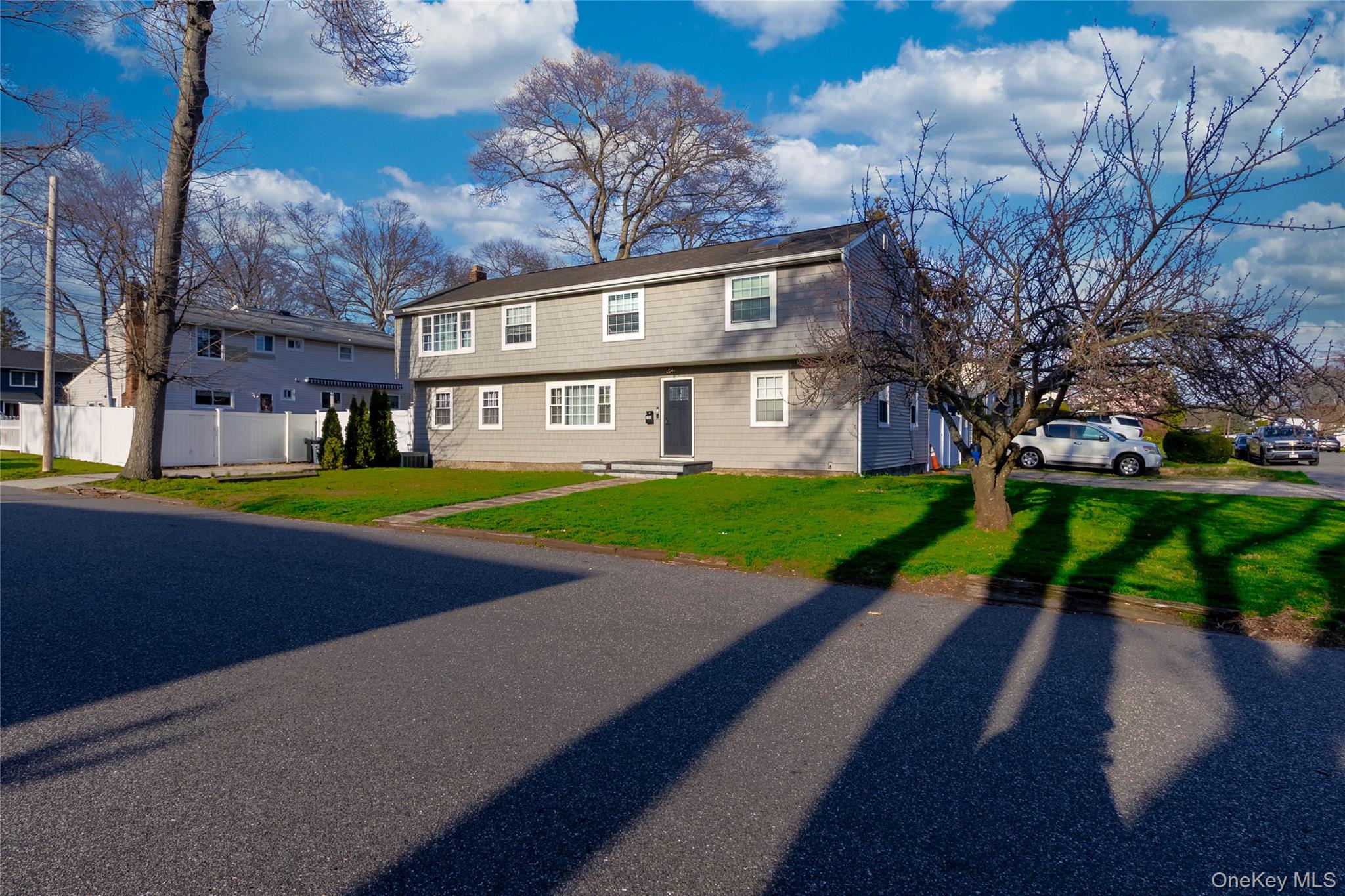 151 Cheltenham Road West Babylon, NY 11704 - Photo 3 of 42 The property features a two-story exterior with light gray siding and white trim