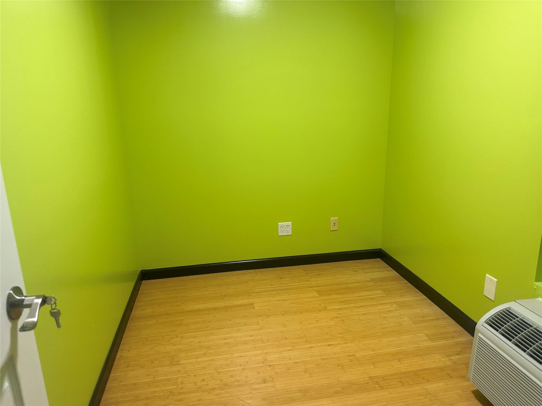 112-02 Northern Boulevard Queens, NY 11368 - Photo 5 of 11 Unfurnished room with light wood-type flooring and a wall unit AC