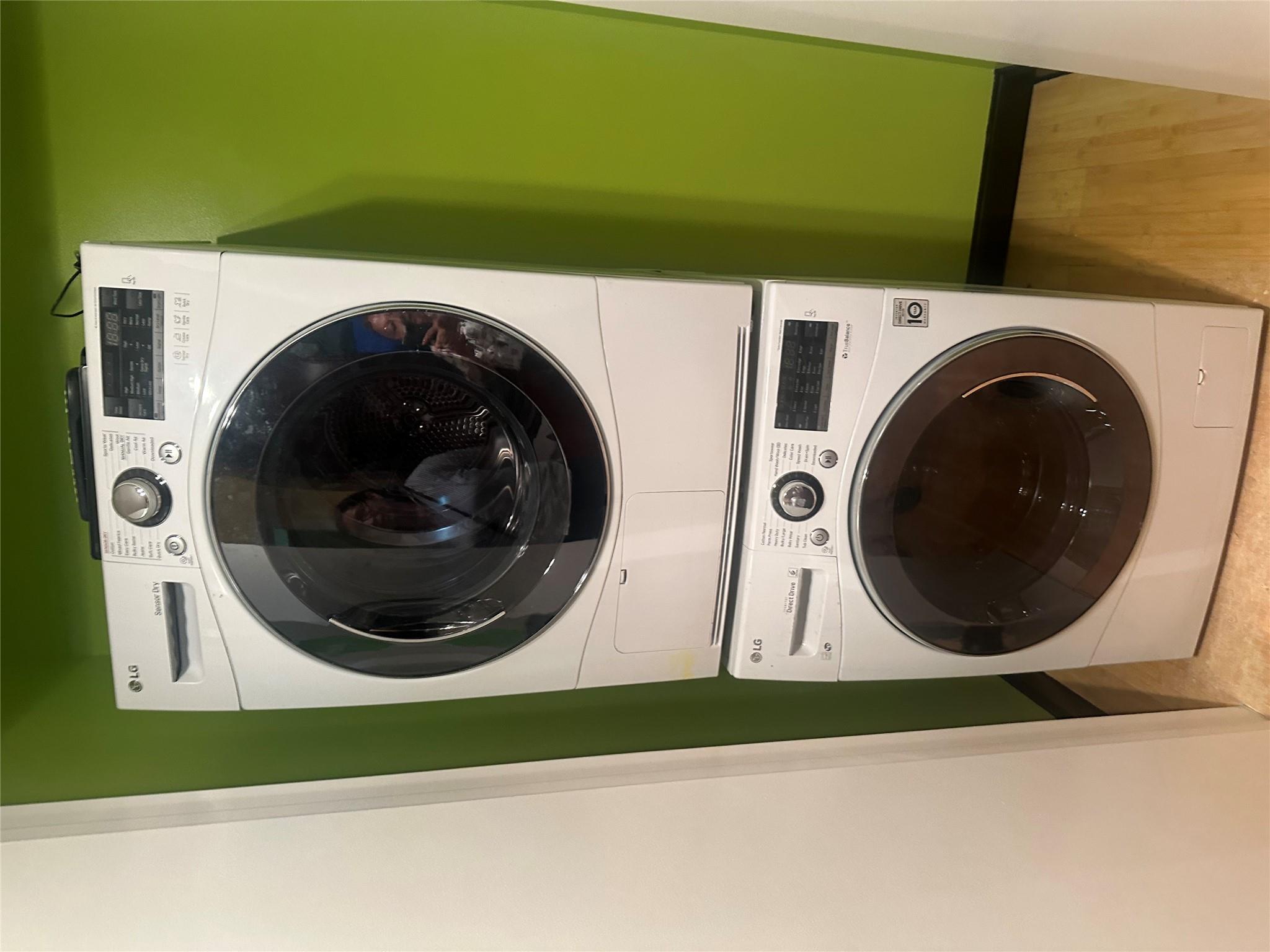 112-02 Northern Boulevard Queens, NY 11368 - Photo 8 of 11 Laundry area featuring stacked washer and clothes dryer and wood finished floors