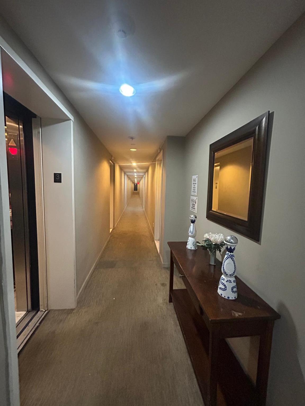 112-02 Northern Boulevard Queens, NY 11368 - Photo 9 of 11 Corridor with carpet floors and elevator