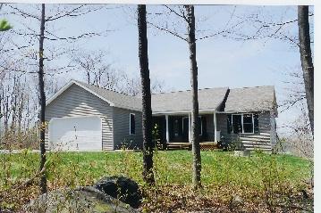 739 George Carter Road Becket, MA 01223 - Photo 1 of 1 a front view of a house with a yard and garage