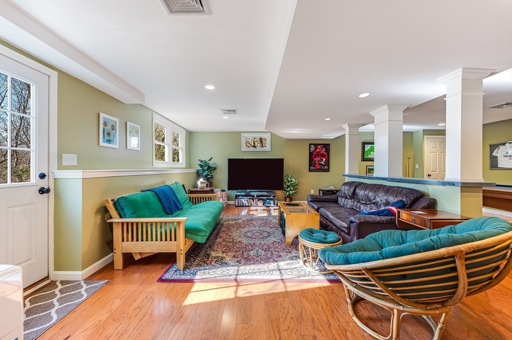 39 Rolling Lane Dover, MA 02030 - Photo 24 of 28 a living room with lots of furniture and a wooden floor