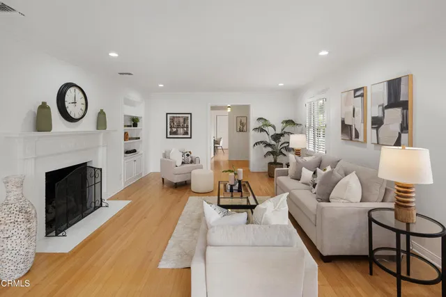 a front view of a house with a yard and a garden