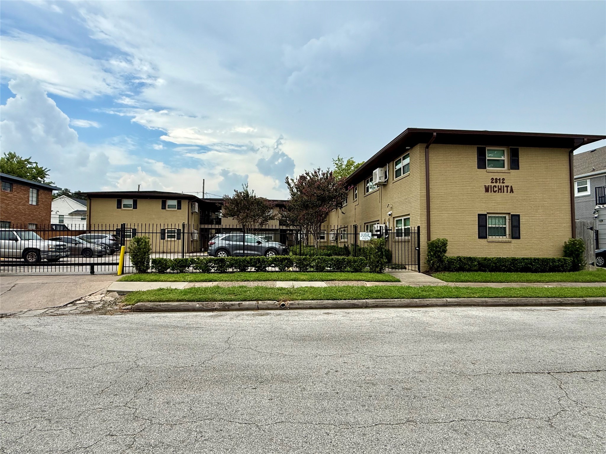 2812 Wichita Street, Unit 6 Houston, TX 77004 - Photo 3 of 15 a front view of a house with a yard table and chairs
