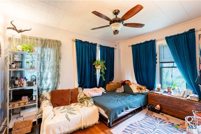 a bedroom with a bed and a window