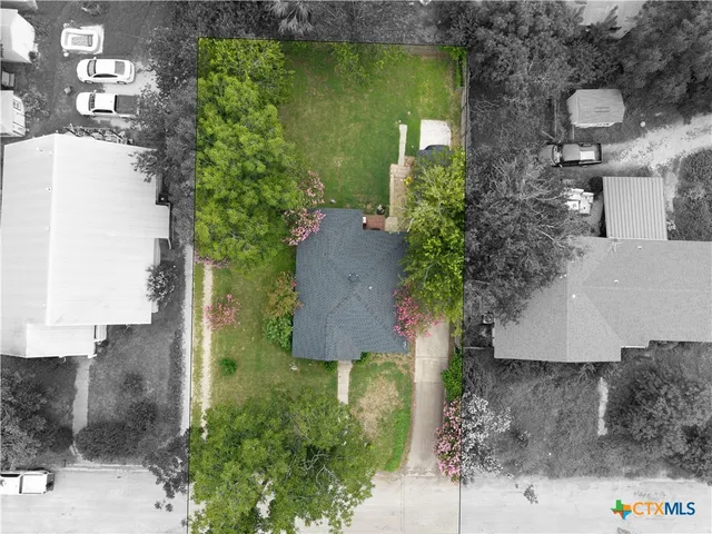 an aerial view of a house with a yard