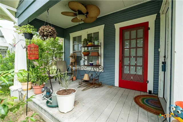 a dining room with furniture and a potted plant