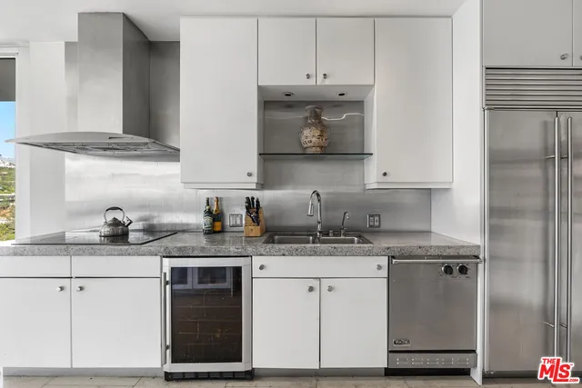 a kitchen with stainless steel appliances granite countertop a sink and cabinets